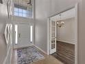 Inviting foyer with a view of the dining room, tile flooring, and decorative wall trim at 7732 Bulls Head Dr, Wesley Chapel, FL 33545