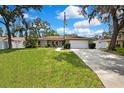 Inviting home exterior with a manicured lawn and walkway leading to the front entrance at 7818 Holiday Dr, Spring Hill, FL 34606