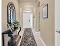 Inviting entryway showcasing stylish decor, a console table, and a decorative rug that leads into the home at 7822 Atwood Dr, Wesley Chapel, FL 33545