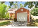 Close-up of the one-car garage featuring an exterior composed of shingle siding at 9466 Forest Hills Cir, Tampa, FL 33612