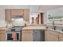 Bright kitchen features stainless steel appliances and light wood cabinets at 9466 Forest Hills Cir, Tampa, FL 33612