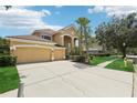 Charming two-story home with a well-manicured lawn, mature landscaping, and a spacious driveway at 10205 Deercliff Dr, Tampa, FL 33647