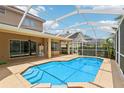 Inviting in-ground pool with screened enclosure and a covered patio, perfect for outdoor enjoyment at 10205 Deercliff Dr, Tampa, FL 33647