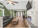 Open-concept living room with modern fireplace, hardwood floors, and ample natural light at 12516 Cobble Stone Dr, Hudson, FL 34667