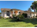 Inviting home exterior with manicured lawn and flowering plants at 13339 Amberwood St, Hudson, FL 34669