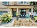 Charming front porch with comfortable seating and attractive landscaping at 15561 Stone House Dr, Brooksville, FL 34604