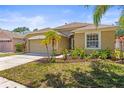 Charming single-story home features a well-manicured lawn, lovely landscaping, and an attached two-car garage at 1611 Cresson Ridge Ln, Brandon, FL 33510