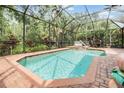 Screened-in pool boasts brick patio and provides a private backyard oasis for relaxation at 19312 Sunset Bay Dr, Land O Lakes, FL 34638