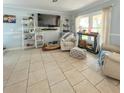 Bright living room featuring tile floors, modern shelving, a neutral palette, and natural light at 22443 Crows Nest Ct, Lutz, FL 33549