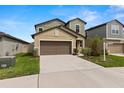 Two-story home with a long driveway, two-car garage, and easy to maintain landscaping at 22489 Storybook Cabin Way, Land O Lakes, FL 34637