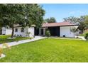 Well-maintained lawn and modern exterior with black and white accents, plus updated landscaping at 2306 S San Jose Cir, Tampa, FL 33629