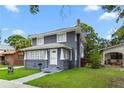 Inviting two-story home with a gray exterior, white trim, and manicured lawn at 2312 Highland S St, St Petersburg, FL 33705