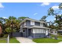 Lovely two-story home featuring a gray exterior, white trim, and lush landscaping at 2312 Highland S St, St Petersburg, FL 33705
