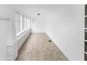Bright sunroom with neutral tile flooring, white walls, and ample natural light at 2312 Highland S St, St Petersburg, FL 33705