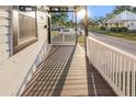 View of the front porch with a white fence, wood flooring and view of neighborhood street at 2315 E 12Th Ave, Tampa, FL 33605