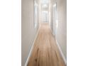 Long hallway with light colored walls, wood floor, baseboard and windows along the wall at 2315 E 12Th Ave, Tampa, FL 33605