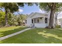 Inviting home showcasing lush landscaping, a cheerful front porch, and a freshly cut lawn at 2519 1St N Ave, St Petersburg, FL 33713