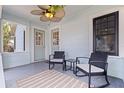 Cozy front porch featuring stylish seating, neutral accents, and a delightful ceiling fan at 2519 1St N Ave, St Petersburg, FL 33713