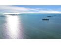 Scenic aerial view featuring calm waters and distant islands under a bright, partly cloudy sky at 2700 Bayshore Blvd # 11308, Dunedin, FL 34698