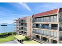 Condo exterior with multiple balconies offering waterfront views and private outdoor seating areas at 2700 Bayshore Blvd # 11308, Dunedin, FL 34698