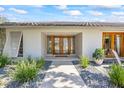 Inviting front entrance with decorative double doors, stone accents, and manicured landscaping at 2900 Sandpiper Pl, Clearwater, FL 33762