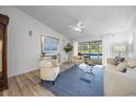 Bright living room features a high ceiling, wood floors, and seamless indoor-outdoor flow at 2900 Sandpiper Pl, Clearwater, FL 33762