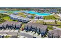 Beautiful aerial view of townhomes near a lagoon community at 31771 Blue Passing Loop, Wesley Chapel, FL 33545