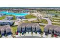 Stunning aerial view of a townhome community with a lagoon at 31771 Blue Passing Loop, Wesley Chapel, FL 33545