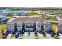Charming exterior of townhomes with blue shutters and well-kept landscaping at 31771 Blue Passing Loop, Wesley Chapel, FL 33545