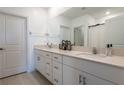 Bright bathroom with double vanity, modern fixtures, and ample cabinet space at 35100 Brackett Bnd, Zephyrhills, FL 33541