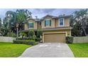 Beautiful two-story home with green shutters, a manicured lawn, and a spacious driveway at 3544 Brook Crossing Dr, Brandon, FL 33511