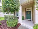 Inviting front porch and door with green wreath adding curb appeal to the entry of this home at 3544 Brook Crossing Dr, Brandon, FL 33511
