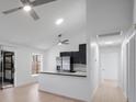 Stylish open-concept kitchen featuring black cabinets, stainless steel appliances, and a bright breakfast bar at 3705 Simpson Ct, Palm Harbor, FL 34684
