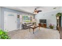 Cozy living room features plush carpeting, a large window, and comfortable seating with decorative touches at 4360 82Nd N Ave, Pinellas Park, FL 33781