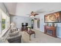Inviting living room boasts a fireplace, large window, and a view to the kitchen with neutral colors at 4360 82Nd N Ave, Pinellas Park, FL 33781