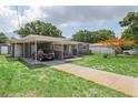 Charming single-story home featuring a covered parking area, and lush landscaping at 4512 S Lois Ave, Tampa, FL 33611