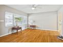 Bright living room featuring hardwood floors, a large window, and neutral walls at 4512 S Lois Ave, Tampa, FL 33611