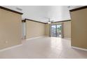 Expansive living room boasts neutral paint, tile flooring, and natural light through sliding glass doors at 4831 Hillman Ter, North Port, FL 34288
