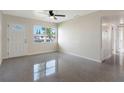 Bright living room with polished floors and large window offering plenty of natural light at 4925 Murray Hill Dr, Tampa, FL 33615