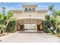 Elegant community entrance with lush landscaping, brick pavers, and a welcoming covered entry at 501 Knights Run Ave # 6104, Tampa, FL 33602
