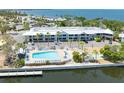 Aerial view of waterfront condo, pool, and pier featuring a beautiful and scenic waterfront community at 611 Destiny Dr # 509, Ruskin, FL 33570