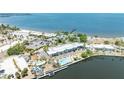 Wide aerial view of the waterfront condos with pool, beach, pier, and surrounding scenic views at 611 Destiny Dr # 509, Ruskin, FL 33570