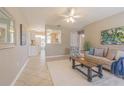 Inviting living room featuring neutral decor, a ceiling fan, a plush rug, and tile flooring throughout at 6702 49Th N Ave, St Petersburg, FL 33709