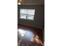 Bedroom with fan, window with blinds, and hardwood floors at 7168 E Bank Dr # 7168, Tampa, FL 33617