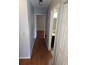 Hallway with hard wood floors leads to multiple rooms and bathroom at 7168 E Bank Dr # 7168, Tampa, FL 33617