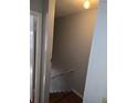 Stairwell with hard wood steps and walls that need paint at 7168 E Bank Dr # 7168, Tampa, FL 33617