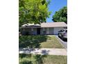Charming single-story home featuring stone accents, well-maintained lawn, and attached one-car garage at 7317 Mitchell Ranch Rd, New Port Richey, FL 34655