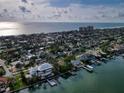 Waterfront homes along the beach featuring private boat docks in a neighborhood with beach and ocean views at 761 Bay Esplanade, Clearwater Beach, FL 33767