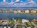 Beautiful waterfront homes along the coast with city and ocean views from above the tree line at 761 Bay Esplanade, Clearwater Beach, FL 33767