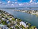 Beautiful aerial shot of homes nestled along the water with private docks, lush landscaping, and a serene ambiance at 761 Bay Esplanade, Clearwater Beach, FL 33767